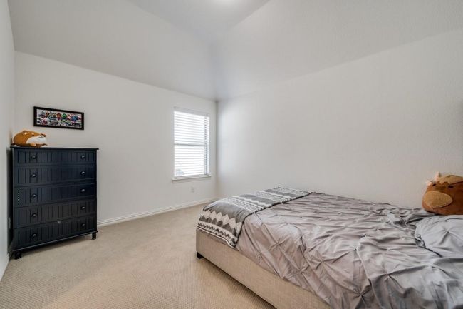 Bedroom with light carpet, lofted ceiling, and baseboards | Image 23
