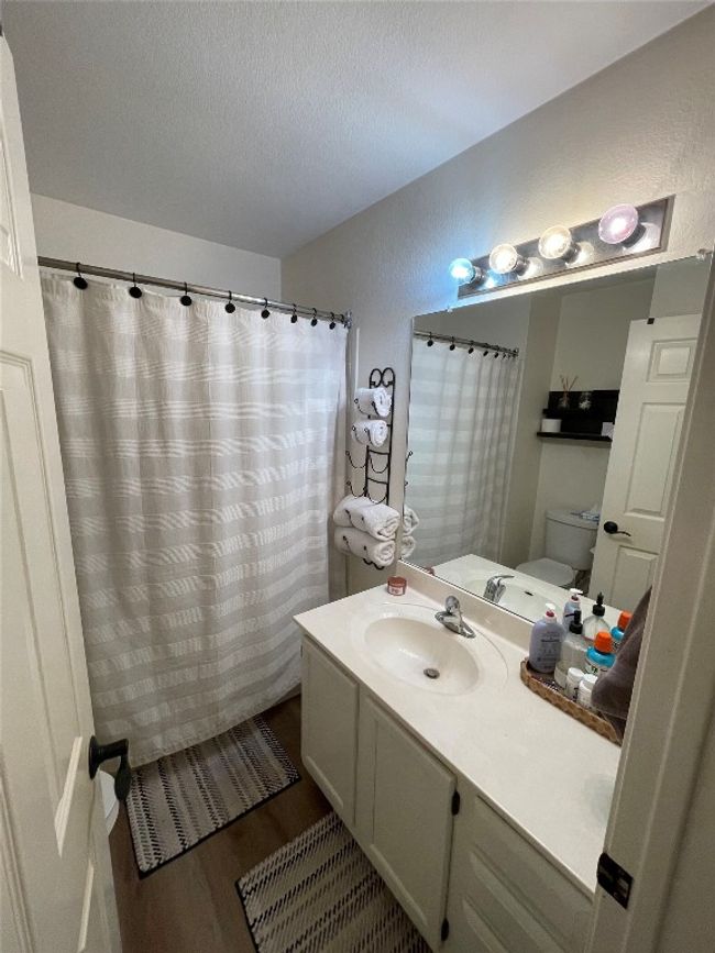 Bathroom featuring wood finished floors, vanity, and a shower with shower curtain | Image 7