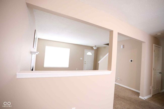 interior space featuring carpet and baseboards | Image 9