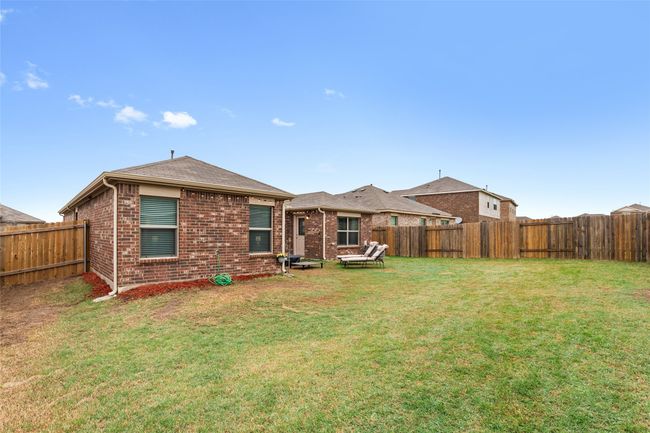 Back of property with a fenced backyard, brick siding, and a yard | Image 32