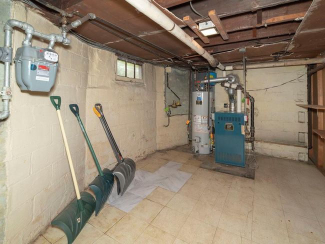 Below grade area featuring water heater and a heating unit | Image 35