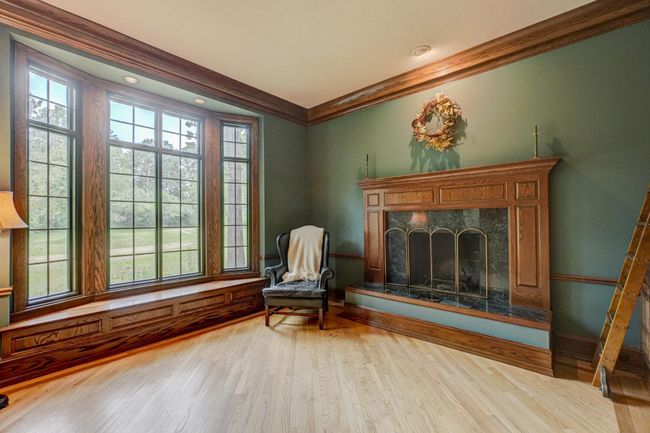 Curl up in front of the marble surround fireplace on a cool autumn day and enjoy the sunlight flooding the room from the large bay window | Image 5