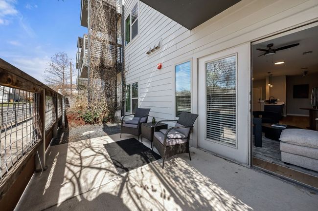 View of patio / terrace with fence and an outdoor hangout area | Image 22