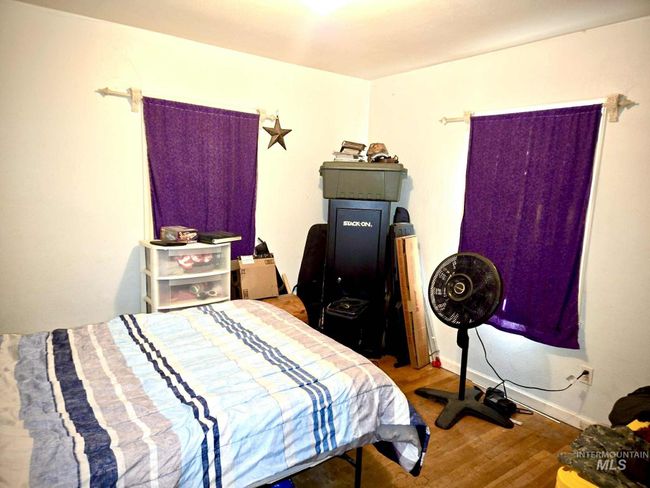 Bedroom with wood finished floors | Image 14