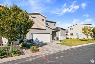 View of property featuring a front lawn and a garage | Image 2