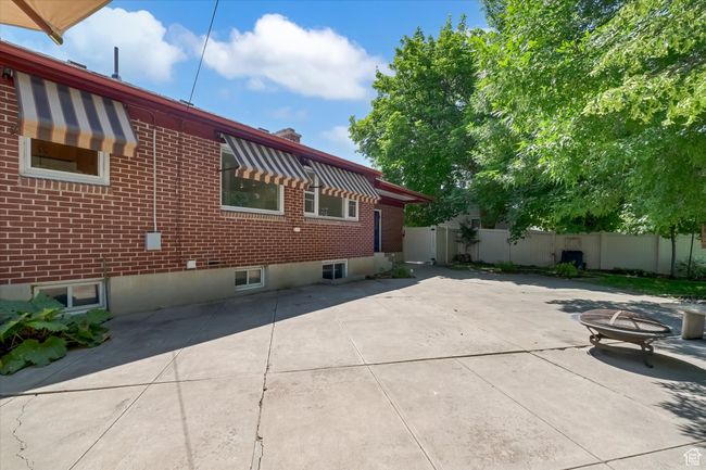 View of home's exterior with brick siding and a patio | Image 32