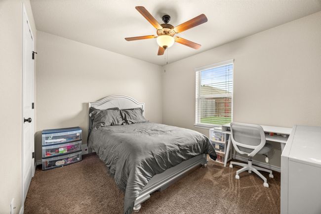 Carpeted bedroom with a ceiling fan | Image 24