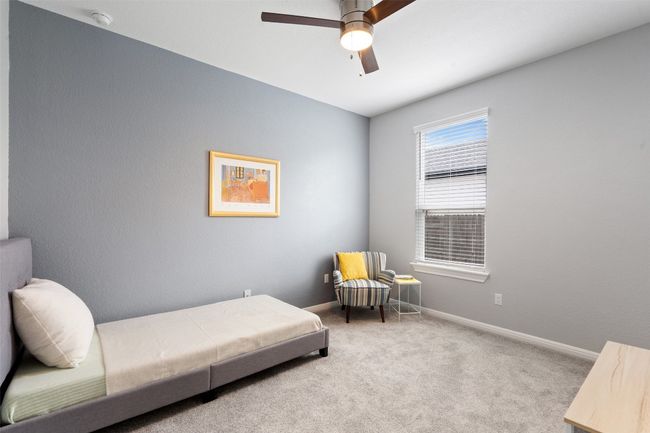 Secondary bedroom with carpet floors, baseboards, and ceiling fan. | Image 27