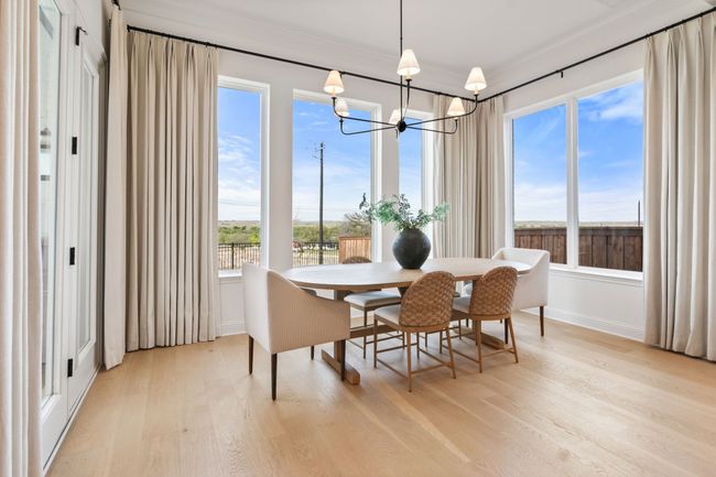 Sunroom with healthy amount of natural light and a chandelier | Image 17