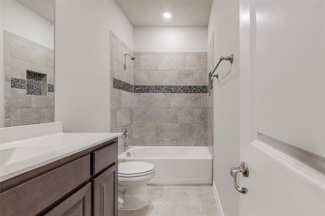 Bathroom with toilet, vanity, tile patterned floors, and shower / bath combination | Image 19