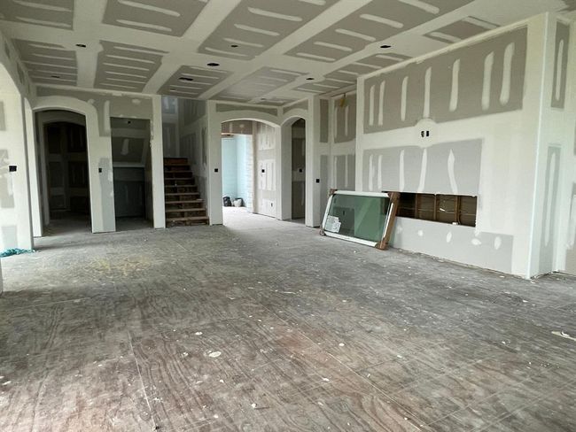 Looking toward the front entry and central stairwell, this shot highlights the home’s oversized under-the-stair closet and future elevator shaft—making beach life accessible for all generations and gear-friendly. | Image 38