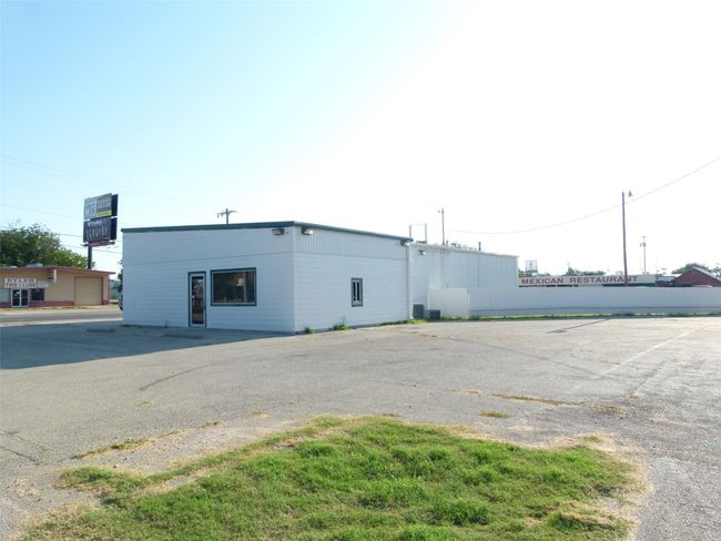View of building exterior featuring uncovered parking | Image 8