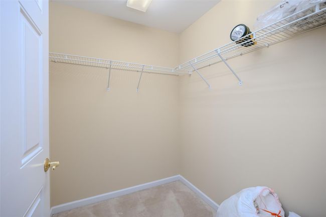 Walk in closet with light carpet | Image 25
