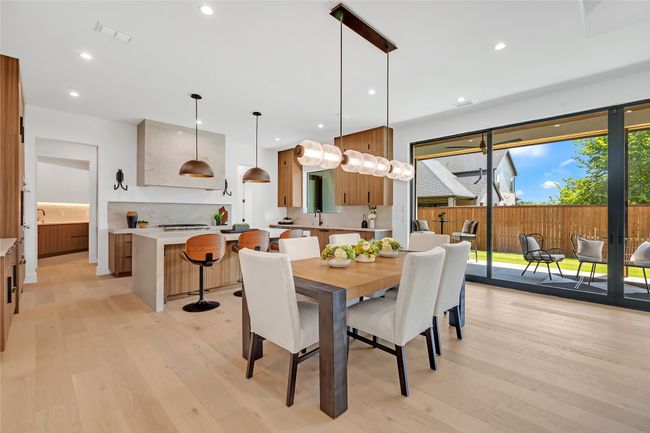 Dining room with light wood-style floors and recessed lighting | Image 7