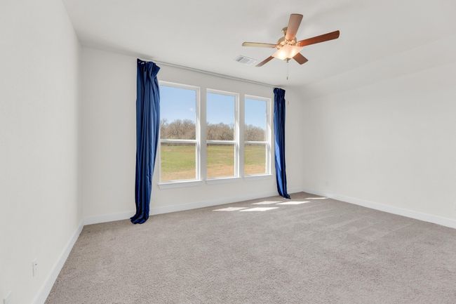 Unfurnished room with a ceiling fan, baseboards, visible vents, and carpet flooring | Image 18