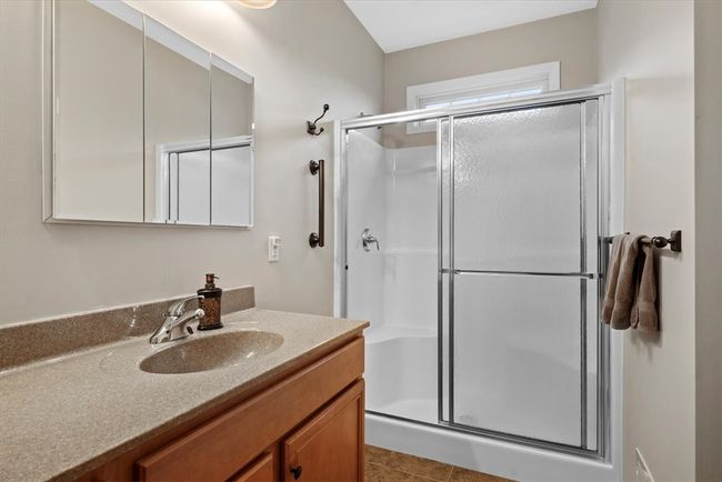 A walk in shower with built in seat and an outer handle bar makes it easy to get in and out of the shower. A window transom provides some natural daylight as well. | Image 19