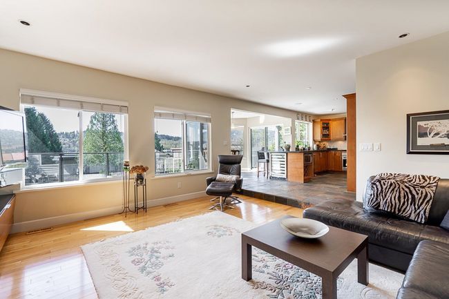 Living area with wood finished floors and recessed lighting | Image 15