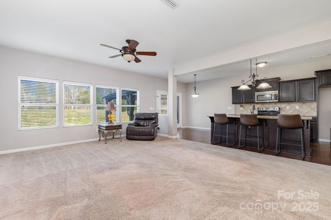 The extensive family room is filled with natural light. | Image 14