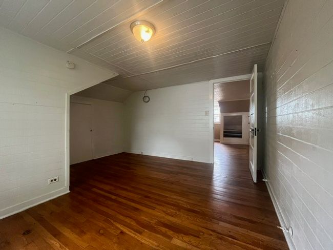 Bonus room with dark wood finished floors and lofted ceiling | Image 28