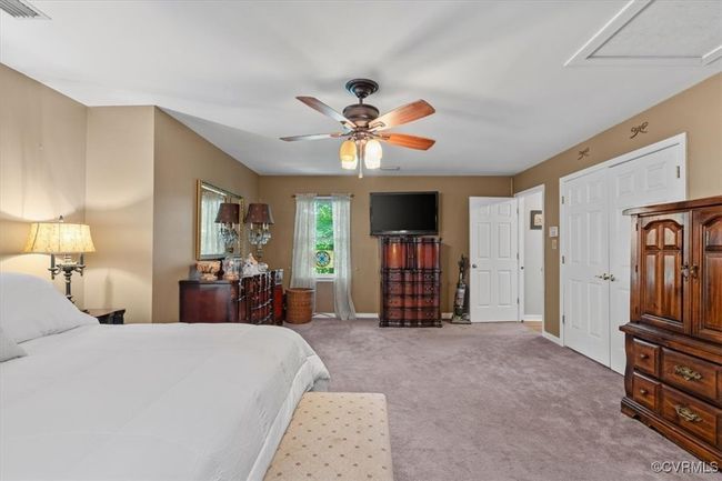 Bedroom with light colored carpet, baseboards, and ceiling fan | Image 30