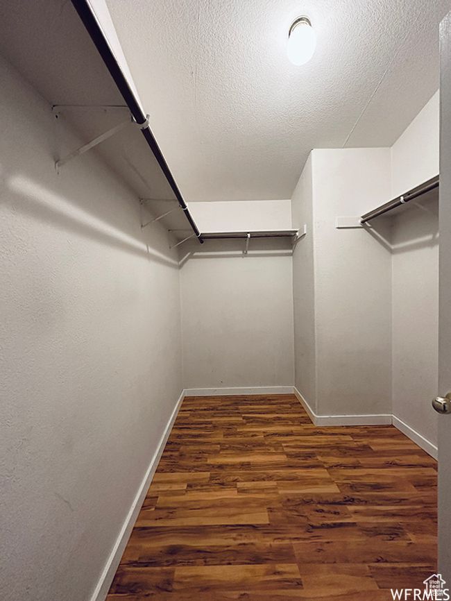Walk in closet featuring wood finished floors | Image 9