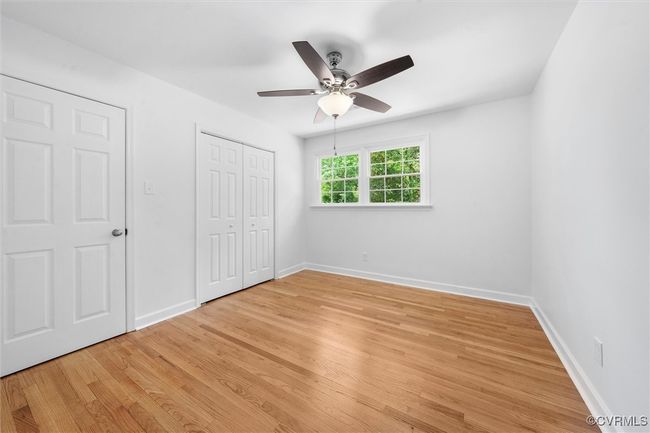 Additional bedroom on second level with hardwoods, ceiling fan, closet, and walk up attic access | Image 19