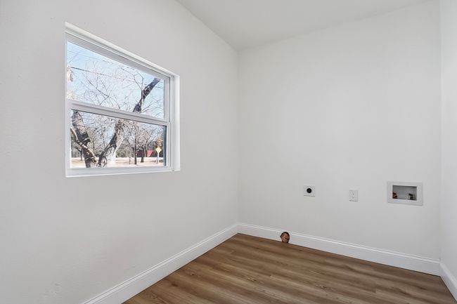 Clothes washing area featuring laundry area, baseboards, wood finished floors, hookup for a washing machine, and hookup for an electric dryer | Image 11