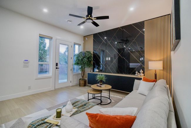Living area featuring wood finished floors, ceiling fan, and baseboards | Image 8