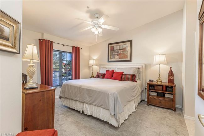 Bedroom featuring ceiling fan, lofted ceiling, and light carpet | Image 14