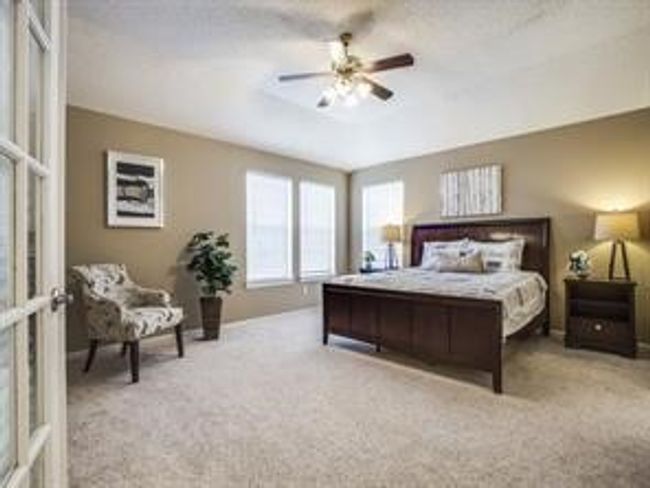 Carpeted bedroom with a ceiling fan | Image 7