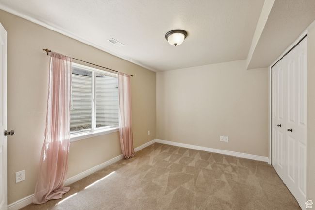 Bedroom with light colored carpet and a closet | Image 34