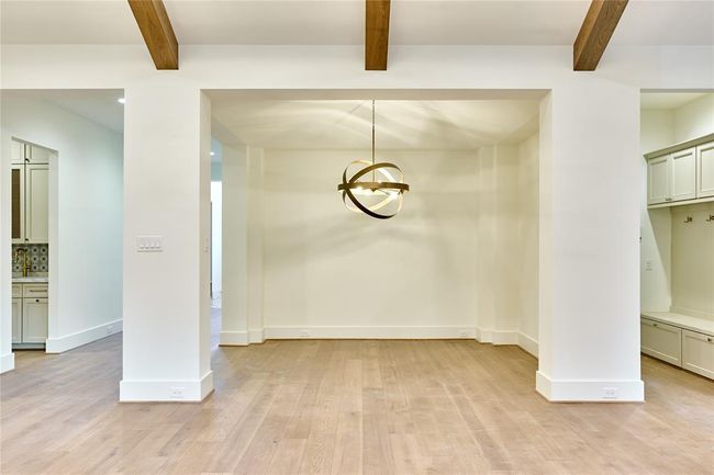 Elegant formal dining room with a striking French-pointed ceiling. | Image 13
