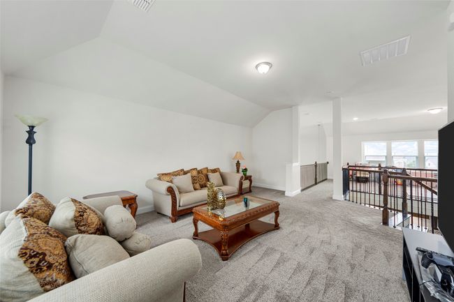 Living room featuring lofted ceiling, light carpet, and baseboards | Image 32