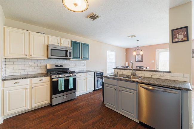 Kitchen also features stainless steel appliances and gas cooking. | Image 7