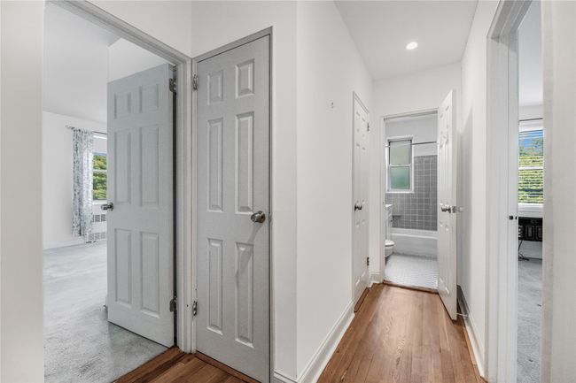 Corridor with healthy amount of natural light, wood finished floors, and recessed lighting | Image 14