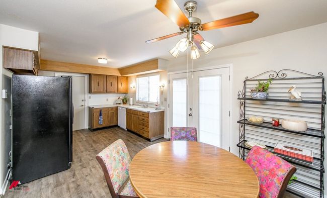 Dining space with ceiling fan and wood finished floors | Image 10