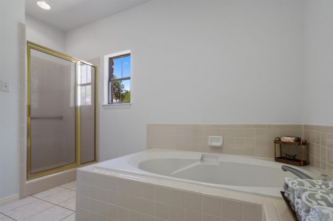 Bathroom featuring a garden tub, tile patterned floors, and a stall shower | Image 22