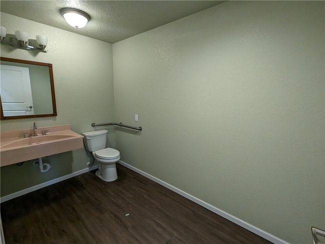 Bathroom with toilet, hardwood / wood-style flooring, and a textured ceiling | Image 17