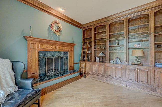 Lose yourself in the magic of the home’s library, where a ladder leads you to a wall of books waiting to be explored | Image 4