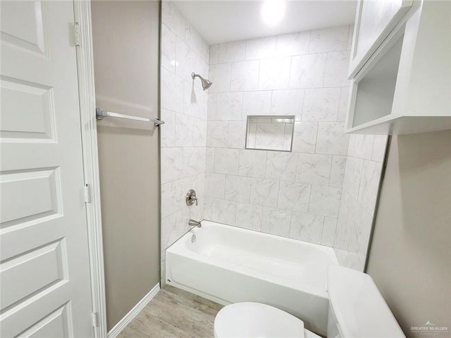 Full bath with shower / bath combination and wood finished floors | Image 17