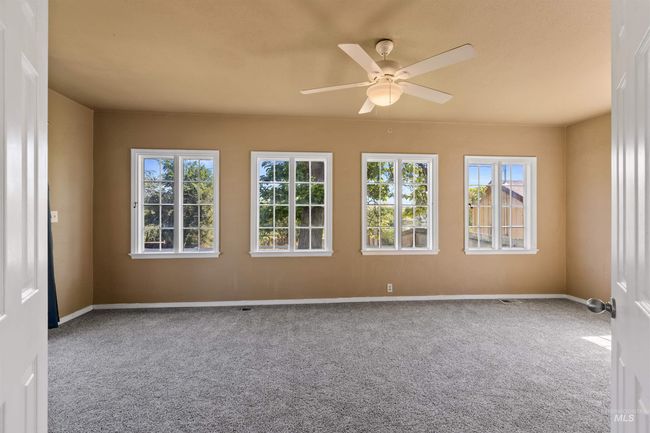 Unfurnished room featuring carpet floors and a ceiling fan | Image 20