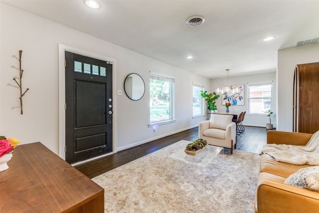 Living room with hand-scraped wood floors, chandelier, and recessed lighting | Image 4