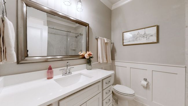 Bright and stylish full bathroom upstairs featuring a linen closet, crisp white finishes, and classic wainscoting—perfect for family or guests. | Image 44