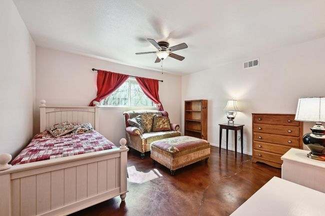 First floor bedroom #1, with a door to the full bathroom. | Image 17