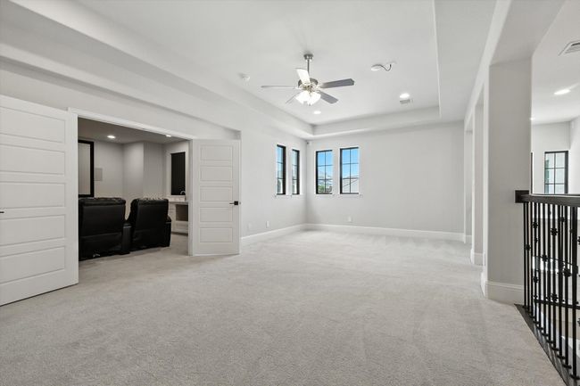 Unfurnished room featuring carpet floors, ceiling fan, plenty of natural light, recessed lighting, and a tray ceiling | Image 28