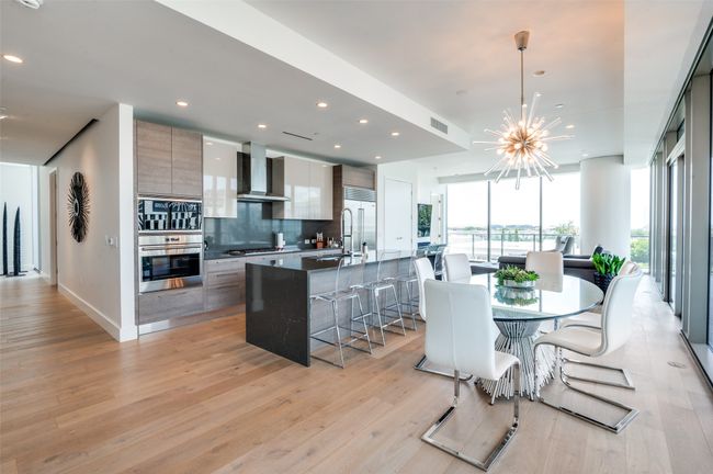 Dining area featuring light wood finished floors, a chandelier, and recessed lighting | Image 9