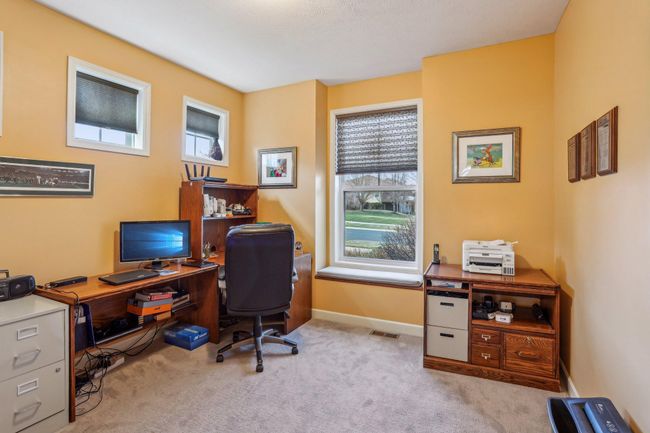 Main level bedroom currently used as an office | Image 19