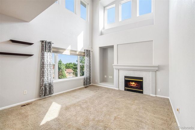 Light-filled Living Room with tall ceiling and fireplace | Image 4