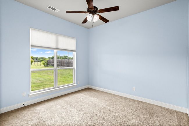 Unfurnished room with carpet flooring, baseboards, healthy amount of natural light, and ceiling fan | Image 28