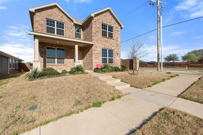 Traditional-style house with a front yard, fence, and brick siding | Image 35